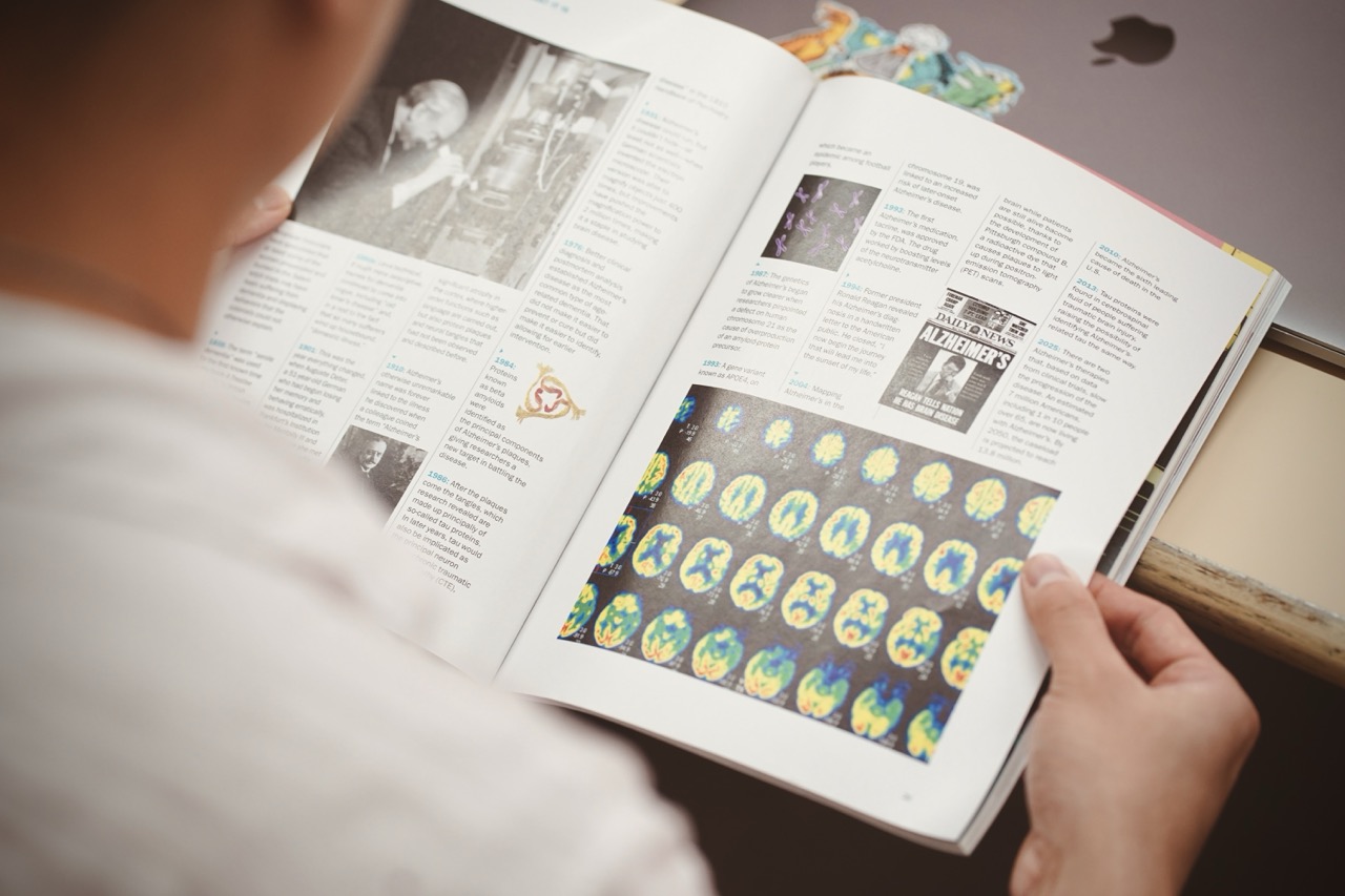 a club member points at a brain diagram on a computer screen